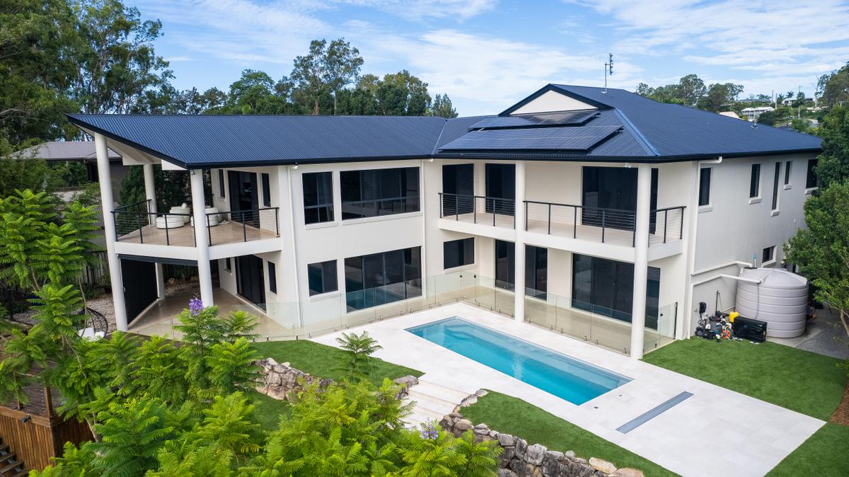 Landscaped family fibreglass pool with lawn and garden on the Gold Coast
