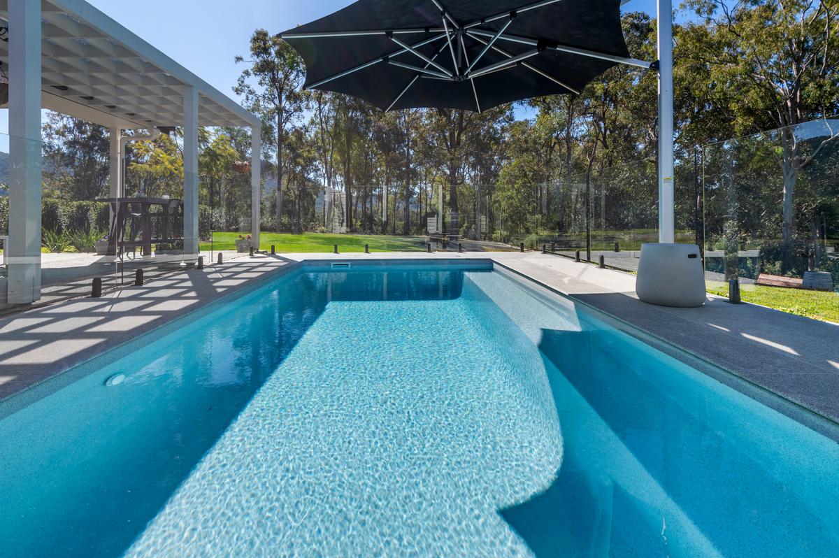 Contemporary fibreglass pool with paved surround and landscaping in Highvale, Brisbane
