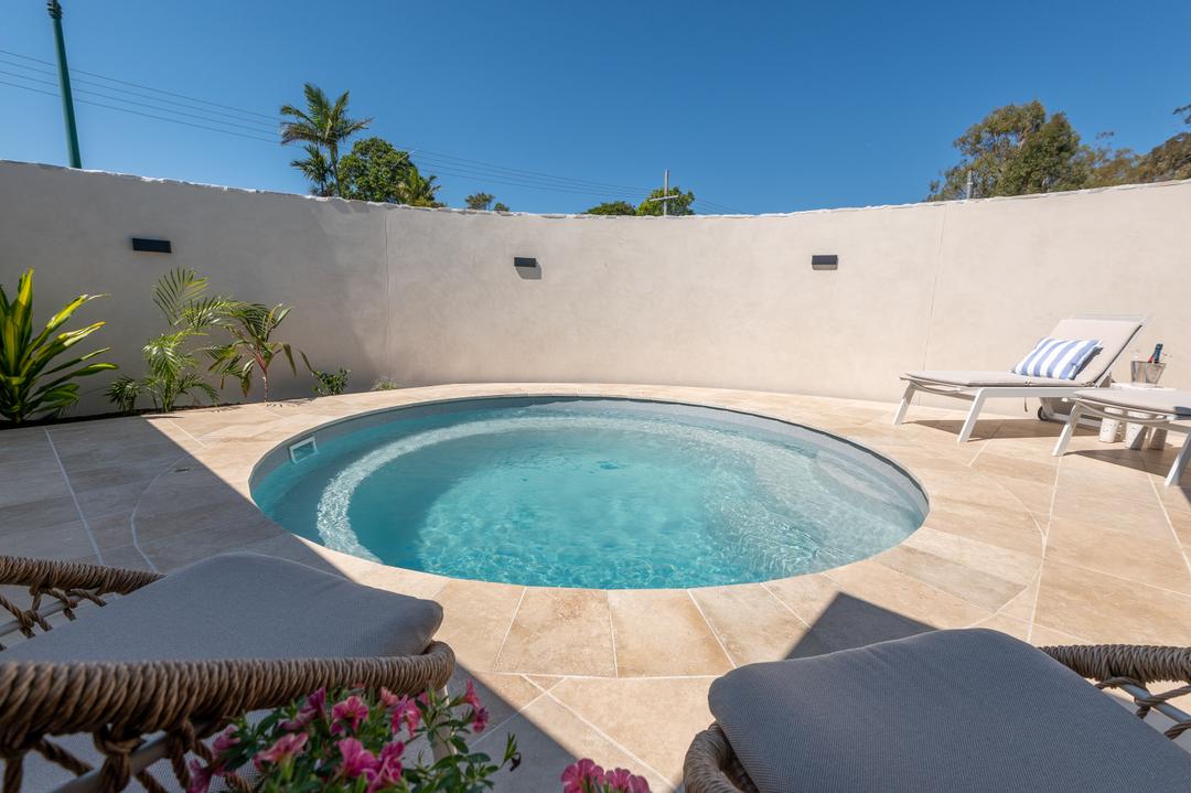 Fibreglass pool with wide full-width entry steps for an easy wade-in