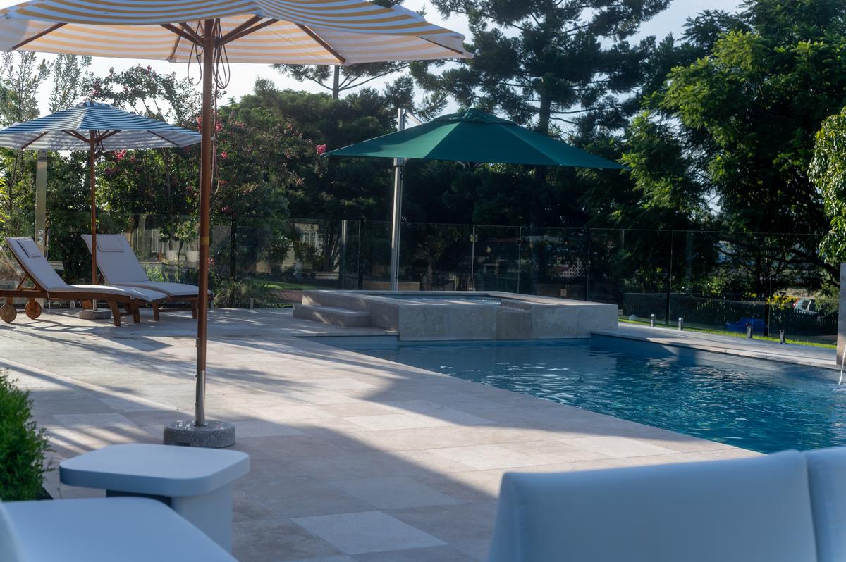 Paver pool surround around a Kensington pool and spa in Booval