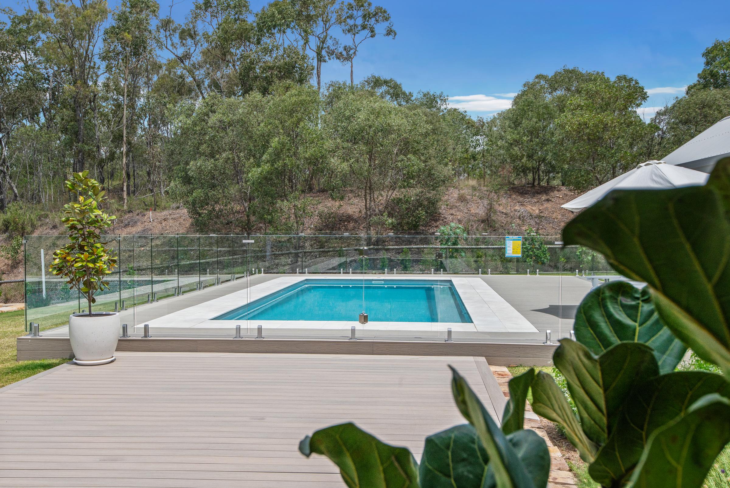 Fibreglass pool with paved surround at dusk